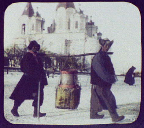 Irkutsk_(-)_-_2_men_(Mongols-)_carrying_load_on_pole_between_their_shoulders;_large_church_in_background_LCCN2004708111